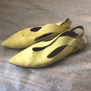 Marsell buttery yellow flats with curved crisscrossing shape that hugs foot.